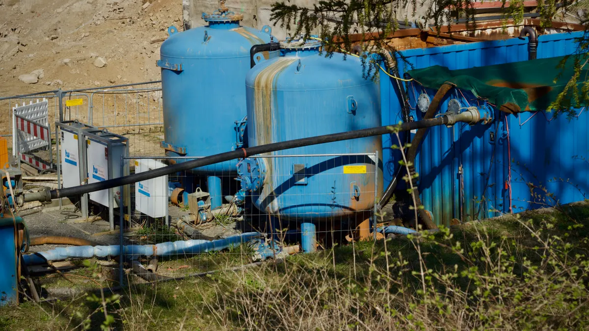blue septic or treatment tanks with pipes outdoors